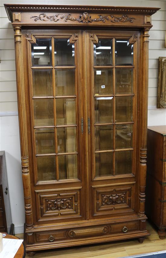 A 19th century French carved walnut Renaissance style two door barred glazed bookcase, H.220cm W.127cm W.127cm.